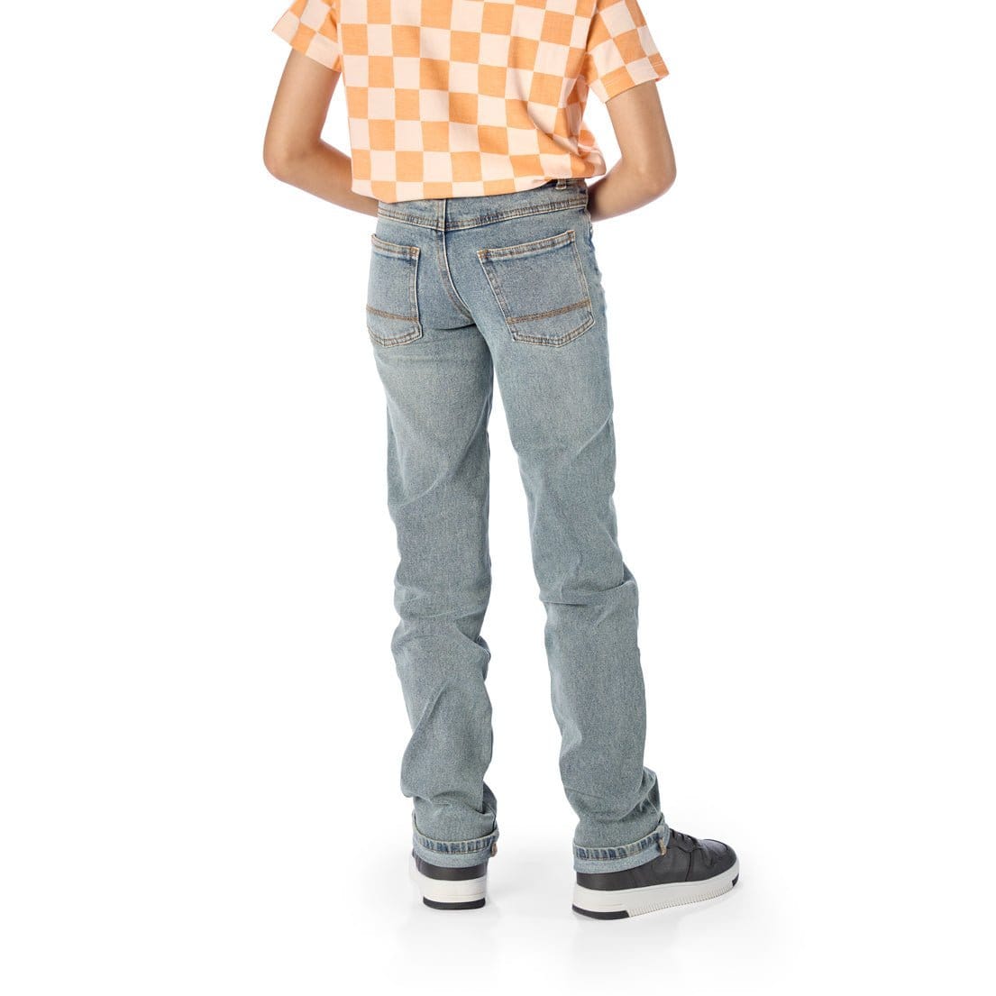 Back of Tall Slim Boy Wearing Slim-Fit Light Wash Jeans / StiltBird Apparel